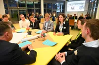 Junge Diskussionsteilnehmende hören gespannt einer Rednerin zu